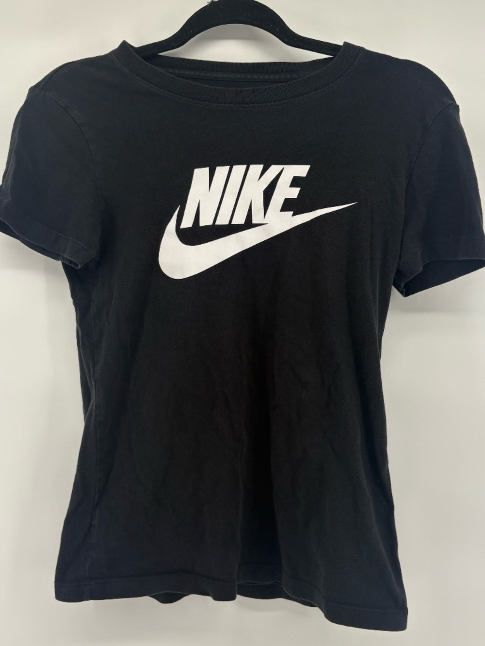 The NIKE tee black short sleeve tee with nike swoosh and logo on front size XS